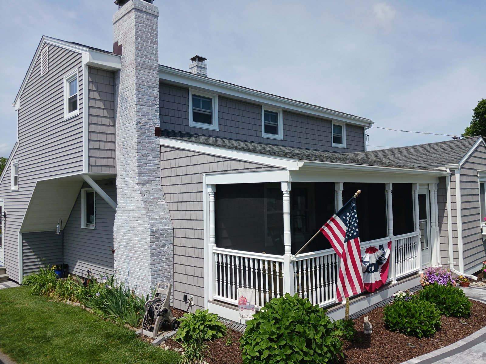 Exterior house — gray siding with white trim and screened porch